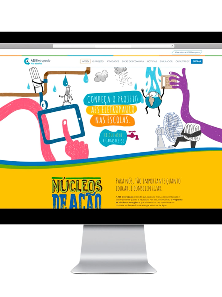 Tela de um computador exibindo o site do projeto "AES Eletropaulo nas escolas", com ilustrações sobre economia de energia e água.