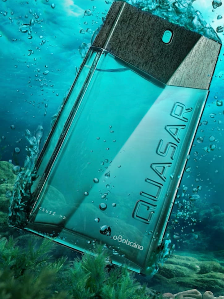 Foto publicitária do perfume Quasar, de O Boticário, com o frasco azul imerso em água.